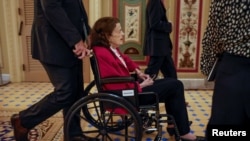 FILE - U.S. Senator Diane Feinstein (D-CA) is pushed in a wheelchair on Capitol Hill in Washington, U.S., Sept. 20, 2023.