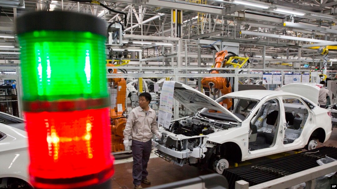 FILE - A worker assembles a car at a factory for Chinese automaker BAIC Motor in Beijing.