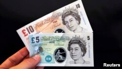 Sample polymer five and ten GB pound banknotes are displayed at the Bank of England in London, Sept. 10, 2013.