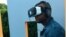Duane Rollins of Washington, D.C., tries an exhibit that simulates solitary confinement. He said "It takes away your humanity," he said. (M. Salinas/VOA)