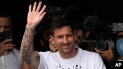 Lionel Messi waves after arriving at Le Bourget airport, north of Paris, Tuesday, Aug. 10, 2021. Lionel Messi finalized agreement on his Paris Saint-Germain contract and arrived in the French capital on Tuesday.