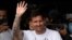 Lionel Messi waves after arriving at Le Bourget airport, north of Paris, Tuesday, Aug. 10, 2021. Lionel Messi finalized agreement on his Paris Saint-Germain contract and arrived in the French capital on Tuesday.