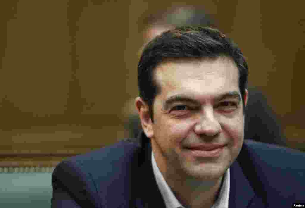 Greek Prime Minister Alexis Tsipras attends the first meeting of the new cabinet in the parliament building telling his ministers that voters had given them a mandate for radical change, in Athens, Jan. 28, 2015.