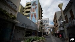 FILE - Shops are seen shuttered in the Paseo de Diego in San Juan, Puerto Rico, April 17, 2019.