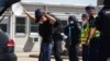 FILE - Austrian and Hungarian police officers attend an exercise to prevent migrants from crossing the Austrian border from Hungary in Nickelsdorf, Austria, July 2, 2020. 