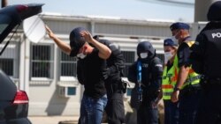 FILE - Austrian and Hungarian police officers attend an exercise to prevent migrants from crossing the Austrian border from Hungary in Nickelsdorf, Austria, July 2, 2020.