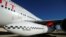 FILE - Richard Branson's Virgin Orbit, with a rocket underneath the wing of a modified Boeing 747 jetliner, prior to a test flight, July 10, 2019.