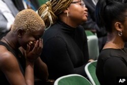 FILE - Guests gather during a public commemoration service for 19 unidentified Black Philadelphians whose remains were part of a display at the University of Pennsylvania's Penn Museum on February 3, 2024, in Philadelphia.