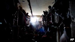 Prisoners cram shoulder to shoulder to watch TV in their crowded cell inside the National Penitentiary in downtown Port-au-Prince, Haiti, Feb. 13, 2017.