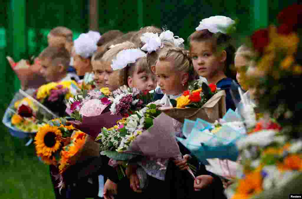 First graders attend a ceremony marking the start of the new school year, as schools reopen after the summer break and the lockdown due to the outbreak of the coronavirus pandemic, in Moscow, Russia.