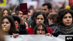 Demonstrators gather in silence in front of the government building in Belgrade, Jan. 24, 2025, after student protest organizers called for a general strike over the fatal collapse of a train station roof in November.