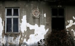 An old Yugoslav coat-of-arms is seen on an abandoned school building in the village of Blagojev Kamen, Serbia, Jan. 23, 2020.