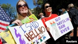 Protesters gather outside the White House for "NoMuslimBanEver" rally against what they say is discriminatory policies that unlawfully target American Muslim and immigrant communities, in Washington, Oct. 18, 2017.