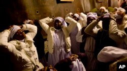 Christian pilgrims from Nigeria pray inside the Grotto of the Church of the Nativity, traditionally believed by Christians to be the birthplace of Jesus Christ, in the West Bank city of Bethlehem on Christmas Eve, Dec. 24, 2014.