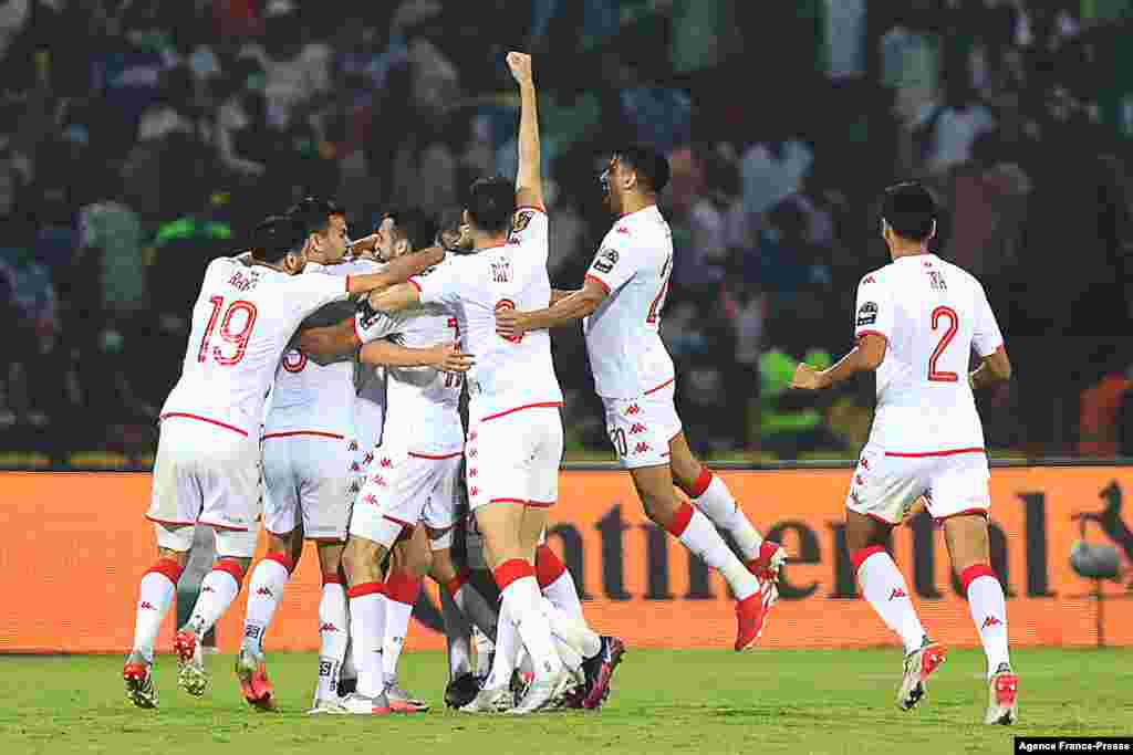 Tunisia&#39;s players celebrate after scoring the opening goal during the round of 16 football match between Nigeria and Tunisia in Garoua, Cameroon on Jan. 23, 2022.