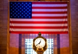 Grand Central clock is pictured in front of the American flag amid the coronavirus pandemic in Grand Central train station April 24, 2020, in New York City.