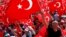 A man waves Turkey's national flag during the Democracy and Martyrs Rally, organized by Turkish President Tayyip Erdogan and supported by ruling AK Party (AKP), opposition Republican People's Party (CHP) and Nationalist Movement Party (MHP), to protest against last month's failed military coup attempt, in Istanbul, Turkey, August 7, 2016. 