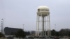 FILE - Vehicles park around a water tower at Fort Riley, Kansas, Feb. 9 2015. According to a criminal complaint filed Monday, a U.S. Army soldier has been arrested after sharing bomb-making instructions online.
