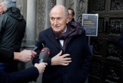 FILE - Former FIFA president Sepp Blatter talks to the media as he arrives before a commemoration service for the former coach of the Swiss national soccer team Koebi Kuhn at the Grossmuenster church in Zurich, Dec. 13, 2019.
