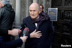 FILE - Former FIFA president Sepp Blatter talks to the media as he arrives before a commemoration service for the former coach of the Swiss national soccer team Koebi Kuhn at the Grossmuenster church in Zurich, Dec. 13, 2019.