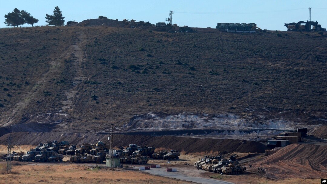 Turkey's forces' tanks and vehicles hold positions close to the border with Syria, near the town of Reyhanli, Oct. 9, 2017. 
