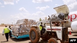 FILE - Airport staff unload cargo sent by Chinese billionaire Jack Ma and his Alibaba Group after it arrives at Juba International Airport, in Juba, South Sudan, March 24, 2020. African health officials say no supplies have reached Eritrea.