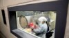 Laboratory scientist Andrea Luquette cultures the novel coronavirus to prepare for testing at the U.S. Army Medical Research and Development Command at Fort Detrick on March 19, 2020. (AP Photo/Andrew Harnik)