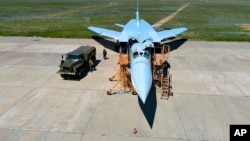 FILE - A crew prepares a Tu-22M3 bomber as part of drills to train for using tactical nuclear weapons, at an undisclosed location in Russia, in this photo released May 21, 2024. (Russian Defense Ministry Press Service/AP)