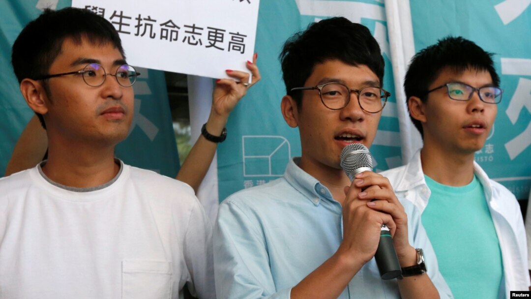 Các sinh viên Nathan Law (giữa), Joshua Wong (phải) và Alex Chow gặp gỡ phóng viên bên ngoài một tòa án ở Hồng Kông, 21/9/2016.
