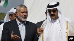 Emir of Qatar Sheikh Hamad bin Khalifa al-Thani, right, and Gaza's Hamas prime minister Ismail Haniyeh, left, during Emir's visit to Gaza Oct. 23, 2012.