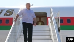 Belarus' President Alexander Lukashenko disembarks from a plane as he arrives at an airport in Sochi on Sept. 14, 2020. 