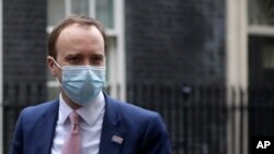 Britain's Secretary of State for Health Matt Hancock arrives at 10 Downing Street in London, Wednesday, Jan. 13, 2021. He said the government is considering many options to ease the strain on the Britain’s National Health Service (NHS).