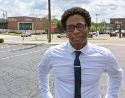 FILE - Wesley Bell stands outside the Ferguson, Mo., police headquarters, Aug. 8, 2018, after he defeated St. Louis County prosecutor Bob McCulloch, in what some saw as a referendum on McCulloch's handling of the police shooting of Michael Brown.