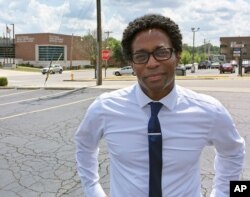 FILE - Wesley Bell stands outside the Ferguson, Mo., police headquarters, Aug. 8, 2018, after he defeated St. Louis County prosecutor Bob McCulloch, in what some saw as a referendum on McCulloch's handling of the police shooting of Michael Brown.