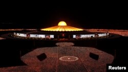 Buddhist monks of the Dhammakaya temple attend a meditation ceremony on Earth Day and light 330,000 candles arranged in the shape of the earth to set a Guinness World Record, in Pathum Thani province, Thailand.