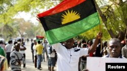 FILE - A supporter of Indigenous People of Biafra (IPOB) leader Nnamdi Kanu holds a Biafra flag during a rally in support of Kanu in Abuja, Nigeria, Dec. 1, 2015