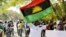 FILE - A supporter of Indigenous People of Biafra (IPOB) leader Nnamdi Kanu holds a Biafra flag during a rally in support of Kanu in Abuja, Nigeria, Dec. 1, 2015