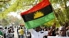 FILE - A man holds a Biafra flag during a rally in Abuja, Nigeria, Dec. 1, 2015.