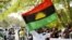 FILE - A man holds a Biafra flag during a rally in Abuja, Nigeria, Dec. 1, 2015.