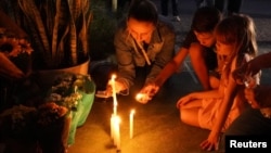 Adultos y niños prenden velas en tributo a cuatro niños que fueron asesinados en una escuela de Blumeau, en el sur de Brasil, el 5 de abril de 20233.