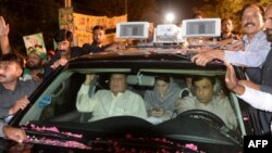 Former Pakistani Prime Minister Nawaz Sharif, center left, sits in a car as he heads back to Kot Lakpat Jail in Lahore, May 7, 2019.