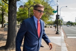 FILE - Michael Flynn, President Donald Trump's former national security adviser, leaves the federal court following a status conference in Washington, Sept. 10, 2019.