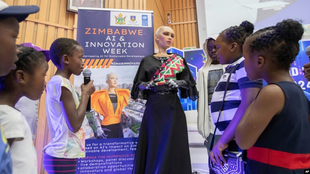 Sophia, the humanoid robot, responds to questions from children at the University of Zimbabwe, Harare, Friday, 13 Dec. 2024. (AP Photo/Aaron Ufumeli)
