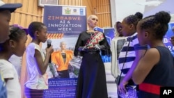 Sophia, the humanoid robot, responds to questions from children at the University of Zimbabwe, Harare, Friday, 13 Dec. 2024. (AP Photo/Aaron Ufumeli)