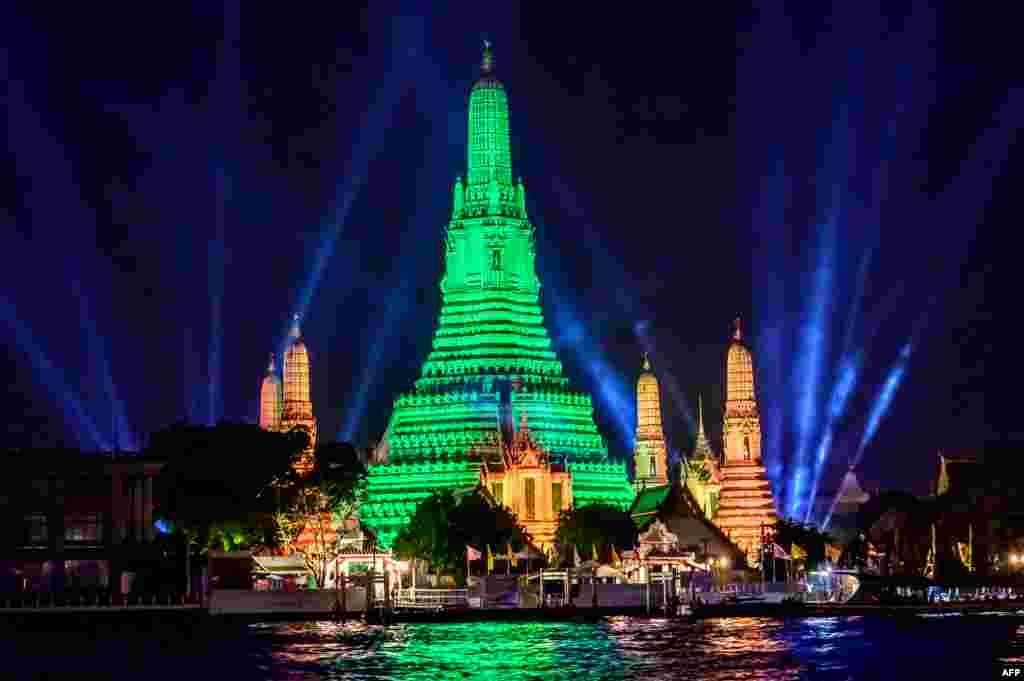 The stupa of the Buddhist temple Wat Arun (Temple of Dawn) is illuminated in green to mark St. Patrick&#39;s Day in Bangkok.