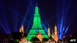 The stupa of the Buddhist temple Wat Arun (Temple of Dawn) is illuminated in green to mark St. Patrick&#39;s Day in Bangkok.