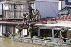 Local residents are rescued by Japapnese Defense Force soldiers from a flooded area caused by Typhoon Hagibis in Kakuda, Miyagi prefecture, Japan, Oct.13, 2019, in this photo taken by Kyodo.