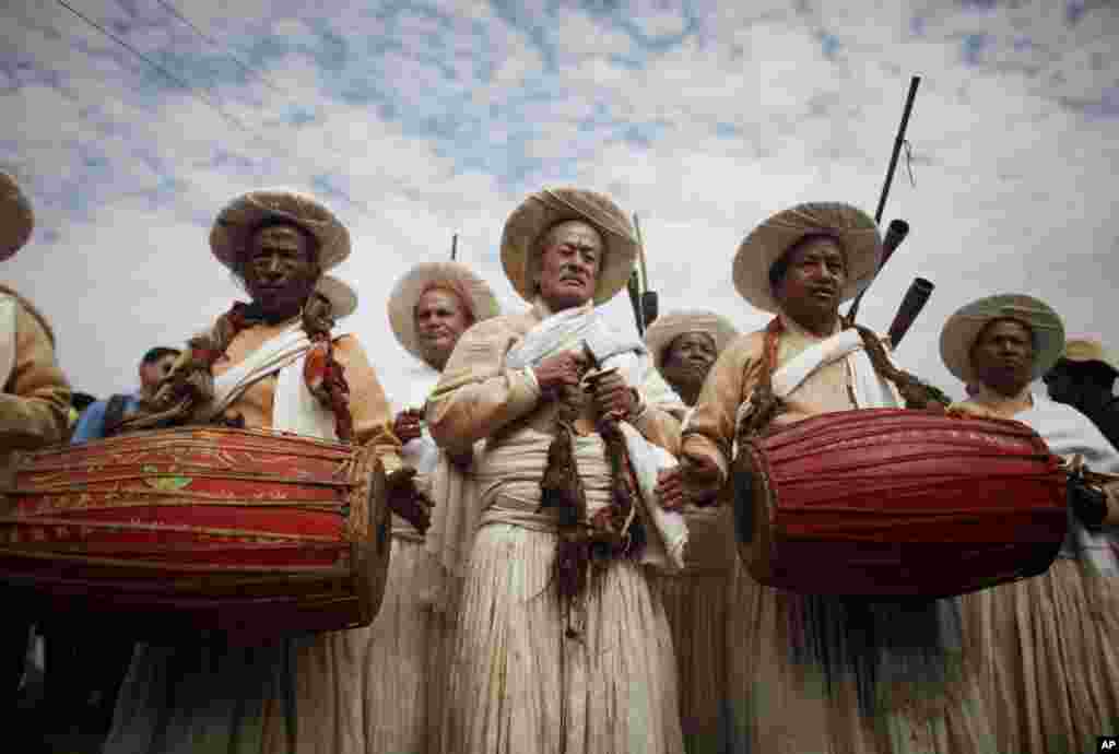 Nepalese priests play traditional instruments during the Shikali festival in Khokana, Lalitpur. The festival is celebrated by the Newar Community from Khokana during which dancers wear masks of various deities, perform dances, and sacrifice animals in the hopes of getting the blessing of deities.