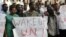 Sudanese protesters hold signs during a demonstration in Tel Aviv against the deportation of migrants from South Sudan, June 10, 2012. 
