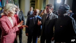 Ursula von der Leyen, left, president of the European Commission, greets Nigerian President Bola Tinubu, right, at the G20 Compact with Africa conference, in Berlin on Nov. 20, 2023.